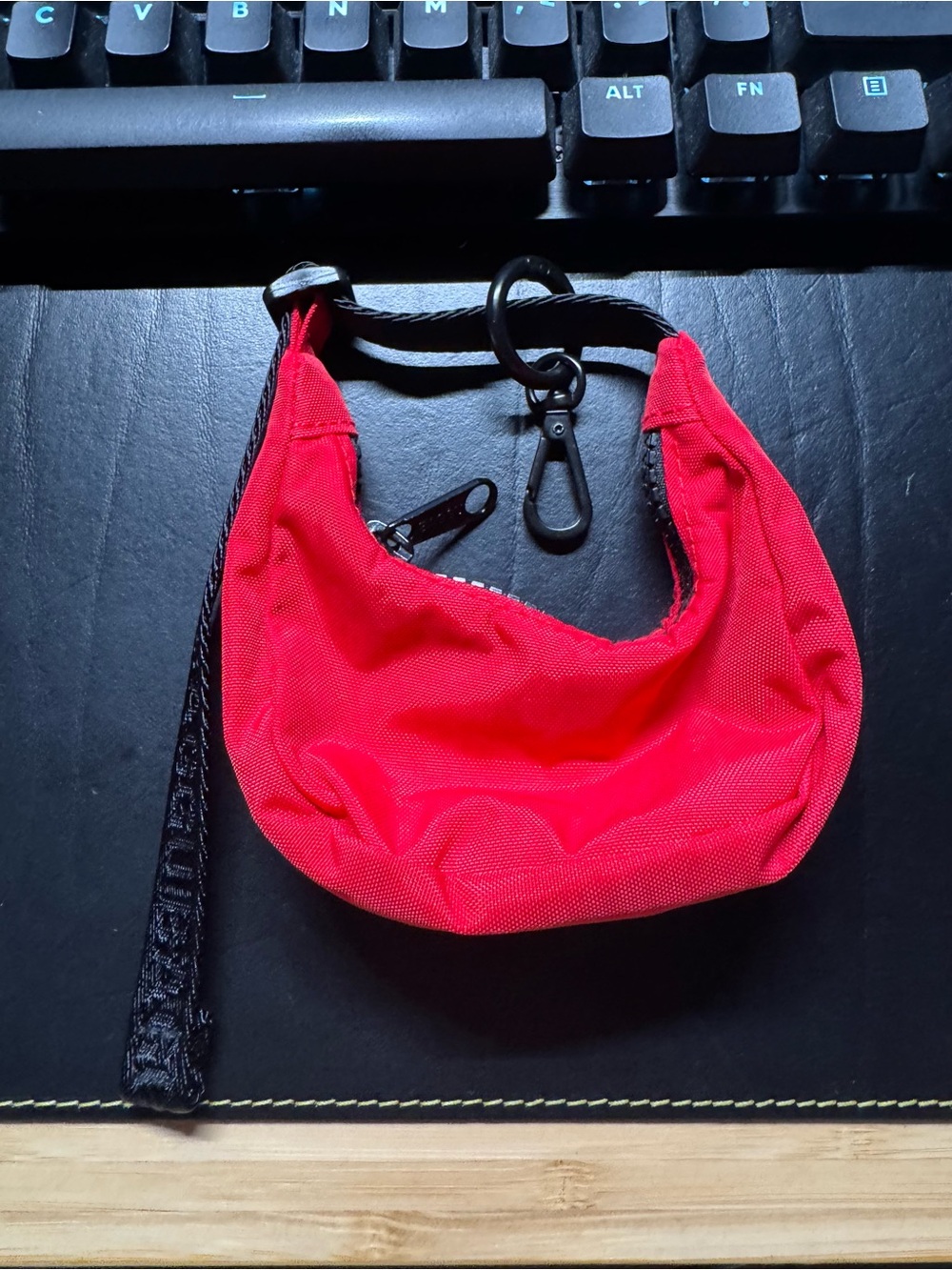 Baggu Crescent Bag Charm in candy apple red.